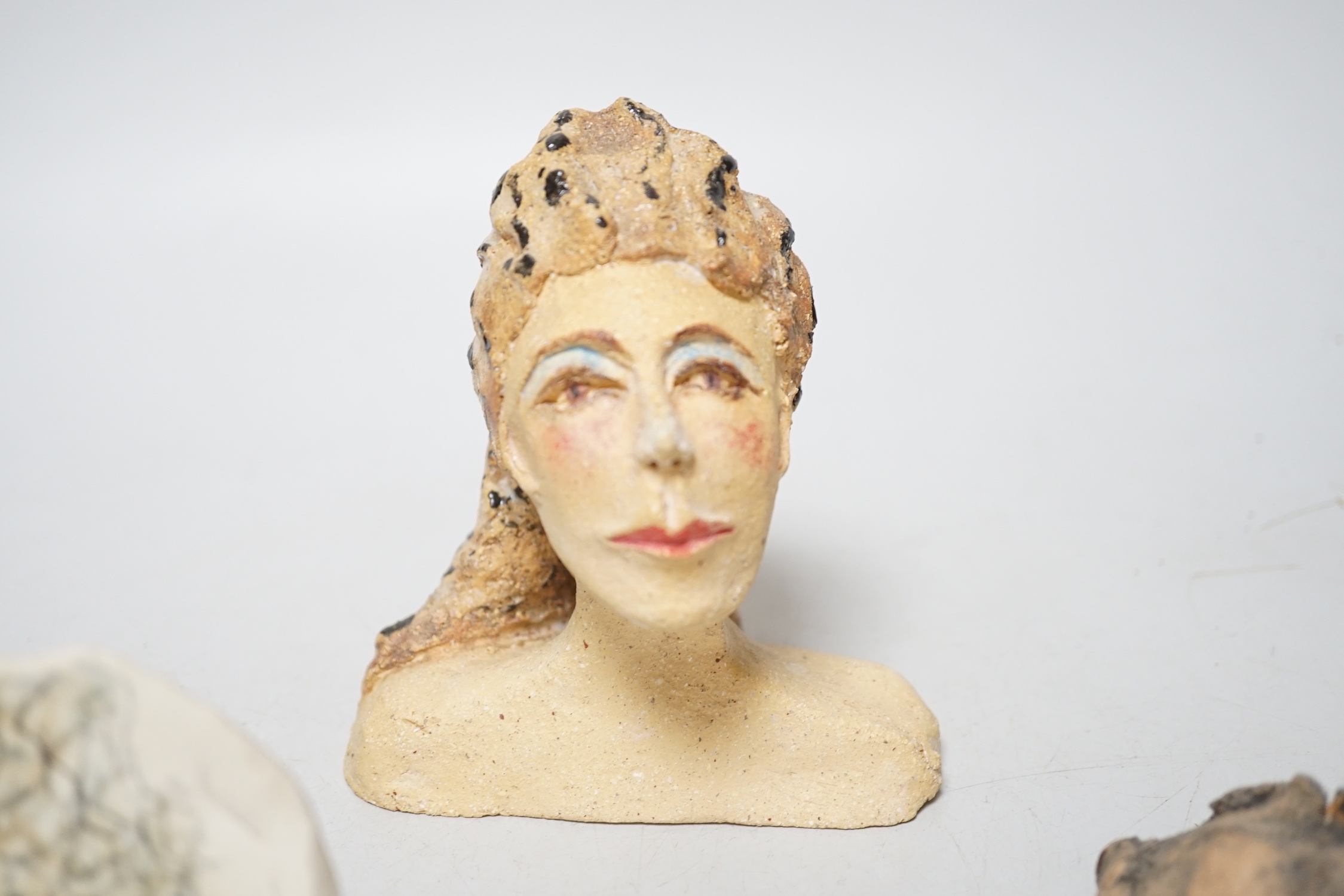 Coral Pearson-Revel (New Zealand) - three works - a painted terracotta head and shoulders of a woman, 12cm, a terracotta woman’s torso, dated 2007 and a half circle plaque, painted with a bust of a woman, each signed
